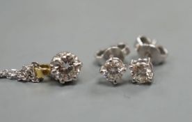 A pair of 18ct and solitaire diamond set ear stud, gross 1 grams and a solitaire diamond pendant