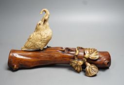 A 19th century Japanese ivory okimono of a kingfisher and log, mother of pearl inset eyes, signed to