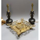 A decorative scroll brass inkstand, together with a pair of lamps, 29cm tall, (3)
