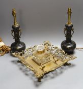 A decorative scroll brass inkstand, together with a pair of lamps, 29cm tall, (3)