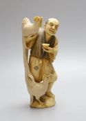 An ivory okimono figure of man with chickens - 16cm high