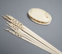 A Japanese ivory model of the clam's dream and five Indian ivory crochet hooks, late 19th/early 20th