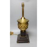 A brass urn lamp, on painted terracotta stepped base, 48cm