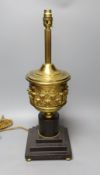 A brass urn lamp, on painted terracotta stepped base, 48cm