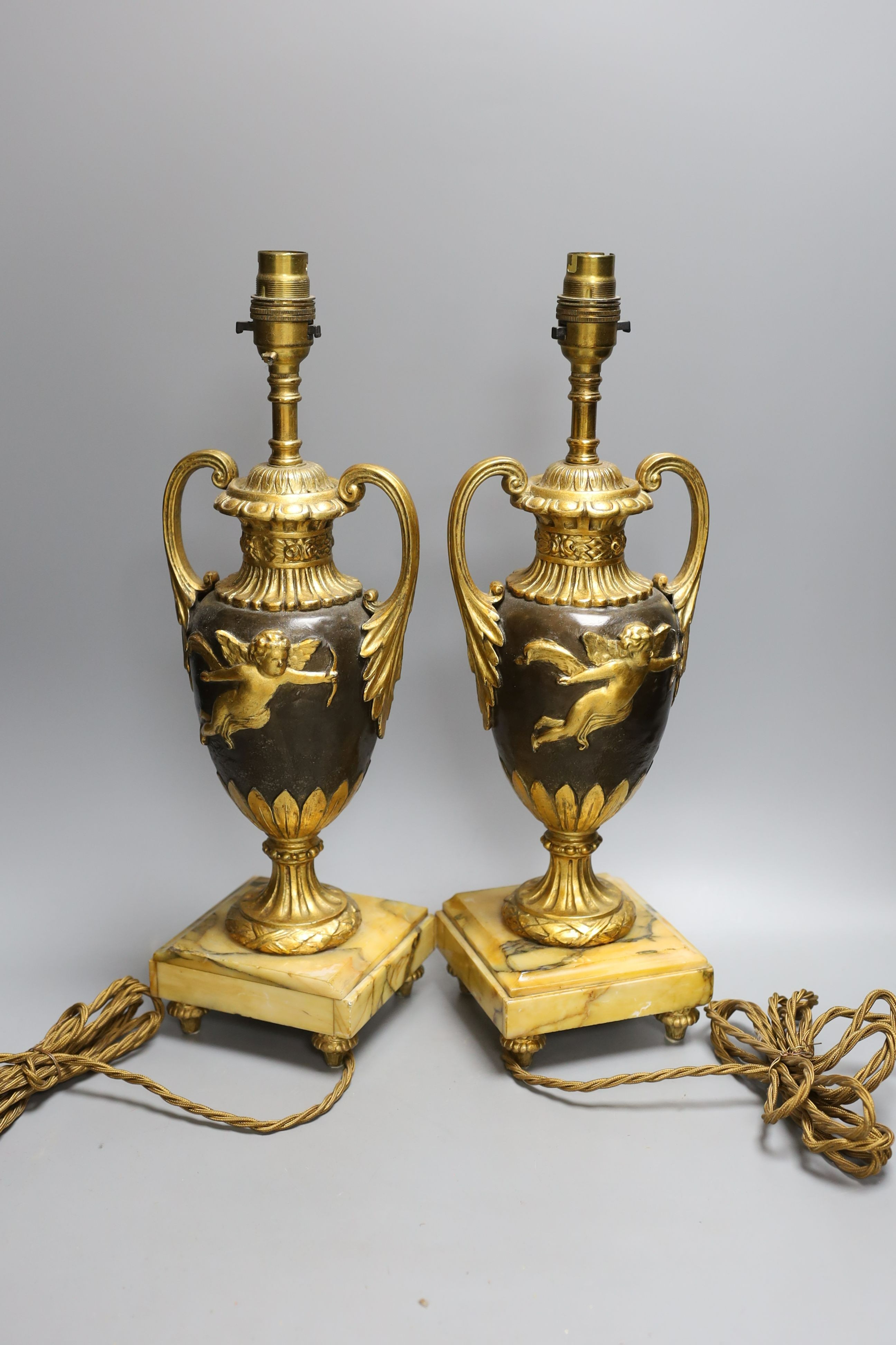 A pair of ornate guilt vase style lamps on marbled base, together with a seated cherub table lamp, - Image 3 of 4