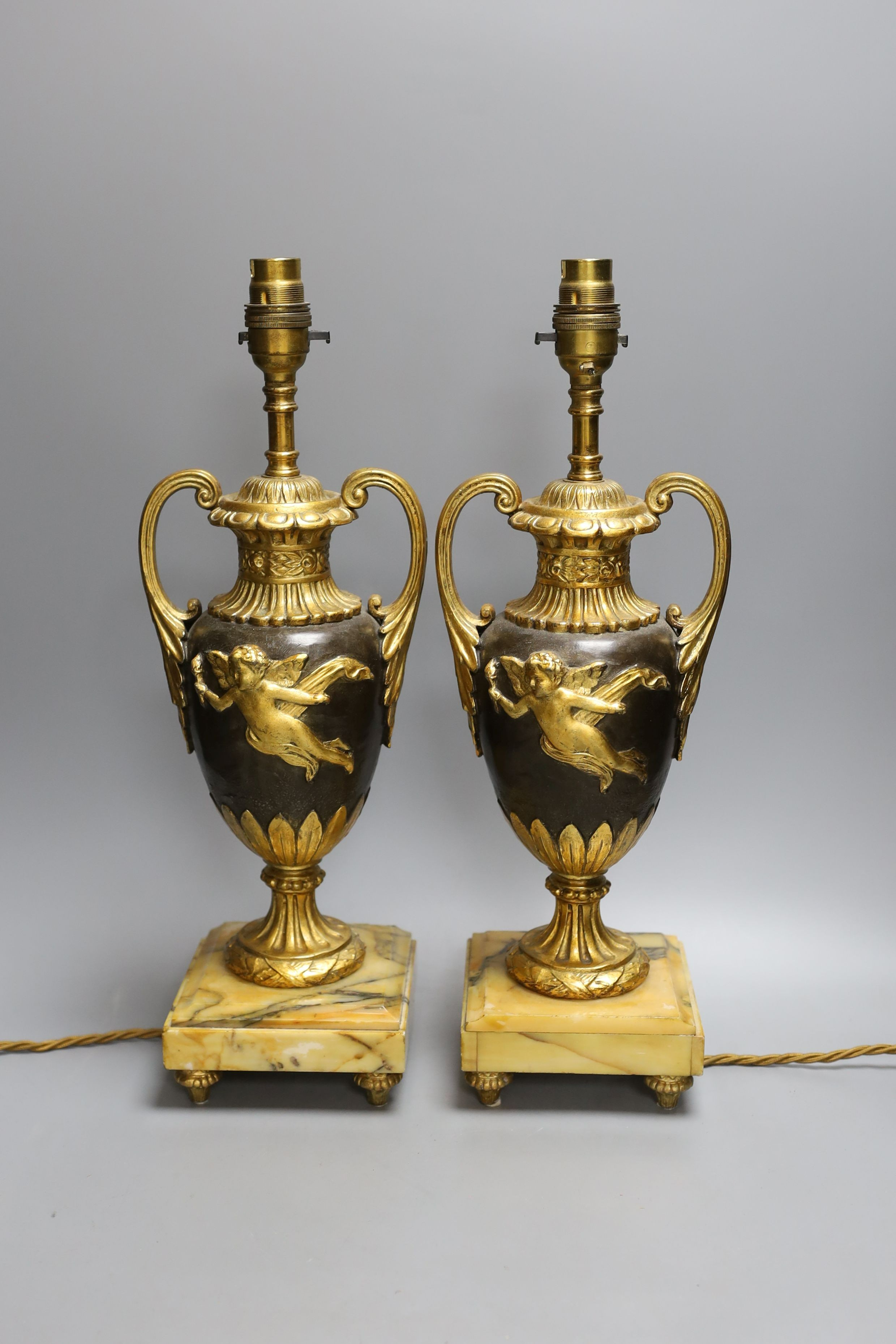 A pair of ornate guilt vase style lamps on marbled base, together with a seated cherub table lamp, - Image 2 of 4