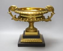 An ormolu urn, on slate plinth, 22cm