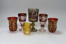 A group of Bohemian coloured glass, including a pair of vine-engraved ruby-flashed wine glasses,