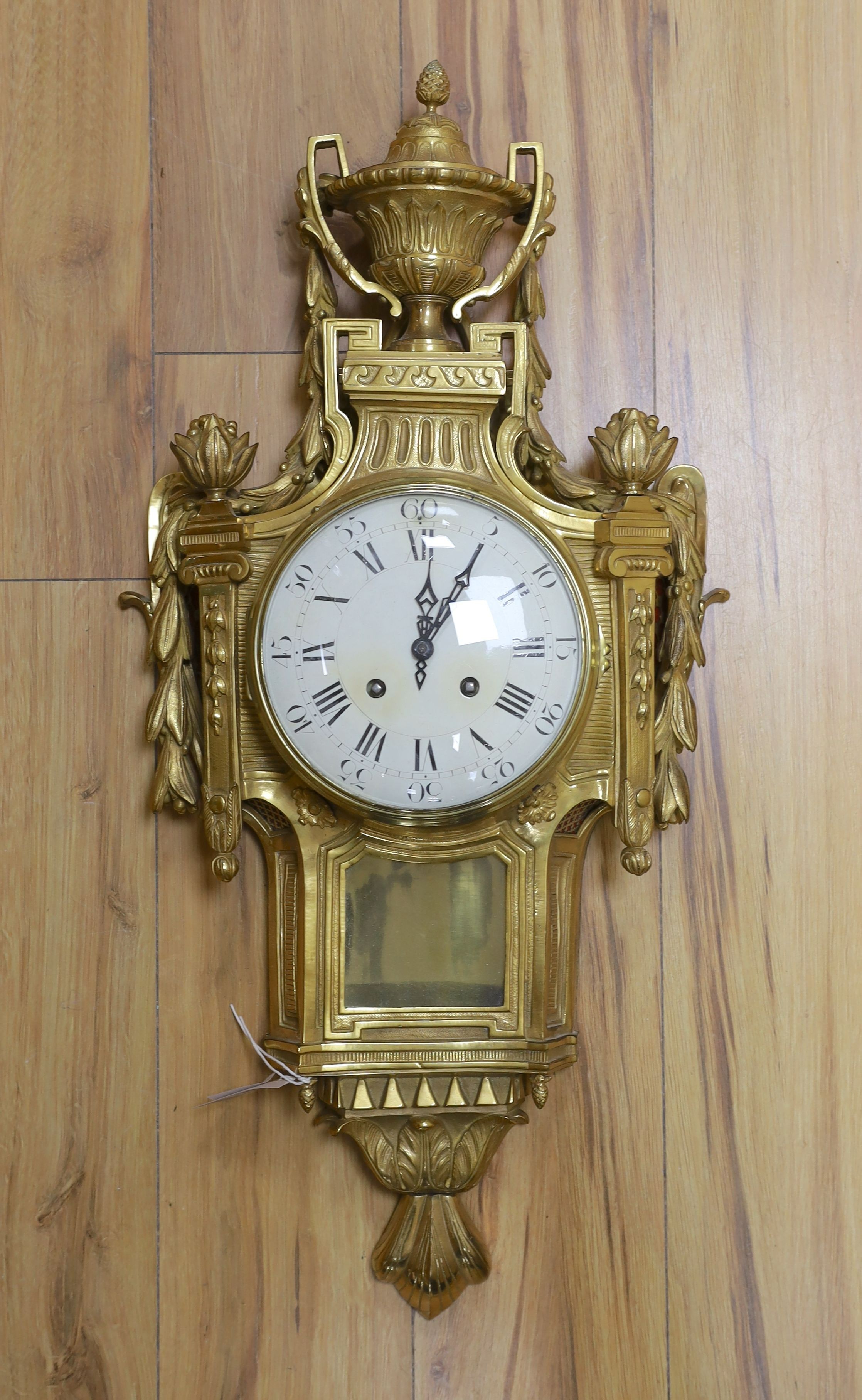 A decorative brass Cartel wall clock - 80cm tall