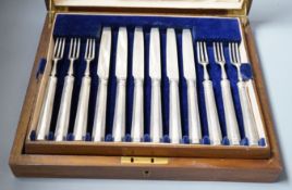 A cased set of twelve silver desert forks and eight silver dessert knives, Thomas Bradbury & Sons,