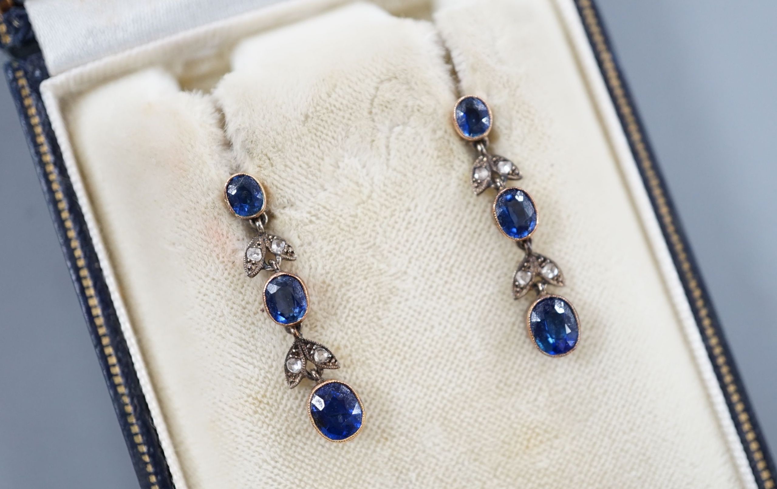 A pair of late Victorian 9ct, three stone sapphire and four stone rose cut diamond set drop