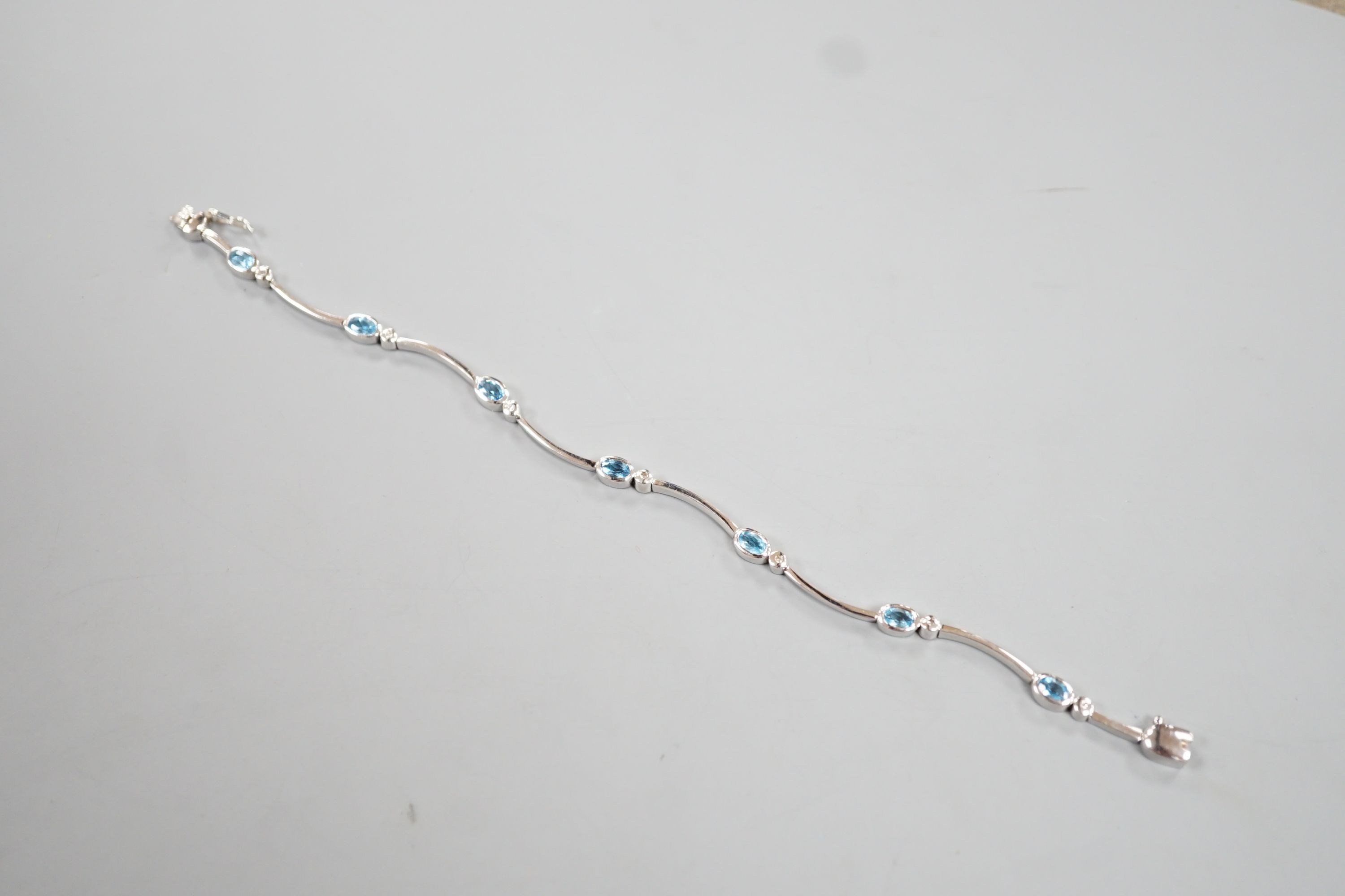 A modern 9ct white gold, blue topaz? and diamond chip set bracelet, 18.5cm, gross 8.8 grams. - Image 3 of 4