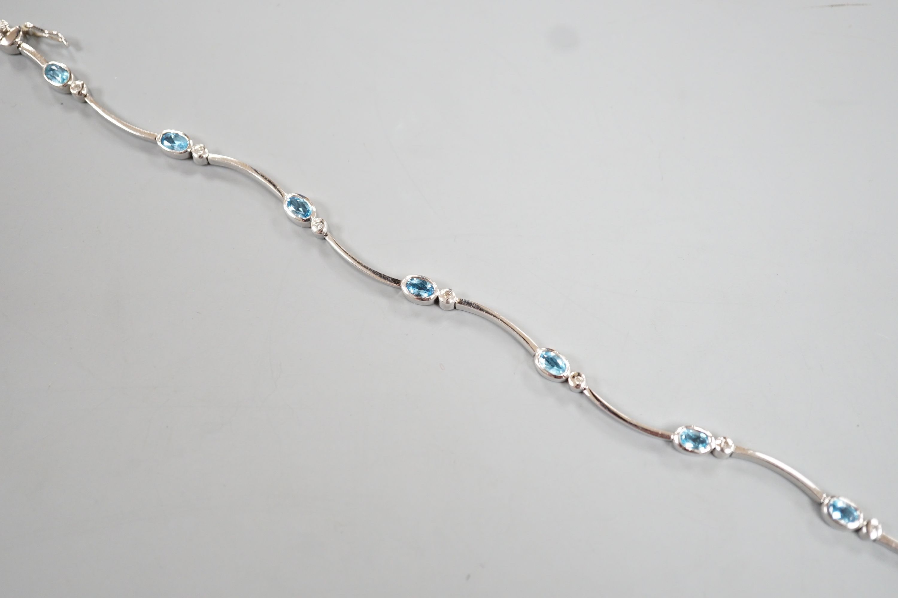 A modern 9ct white gold, blue topaz? and diamond chip set bracelet, 18.5cm, gross 8.8 grams. - Image 2 of 4