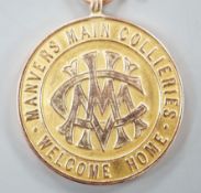 A WW1 related 9ct gold 'Manvers Main Collieries Welcome Home' medallion, presented to W.H. Cavanagh,