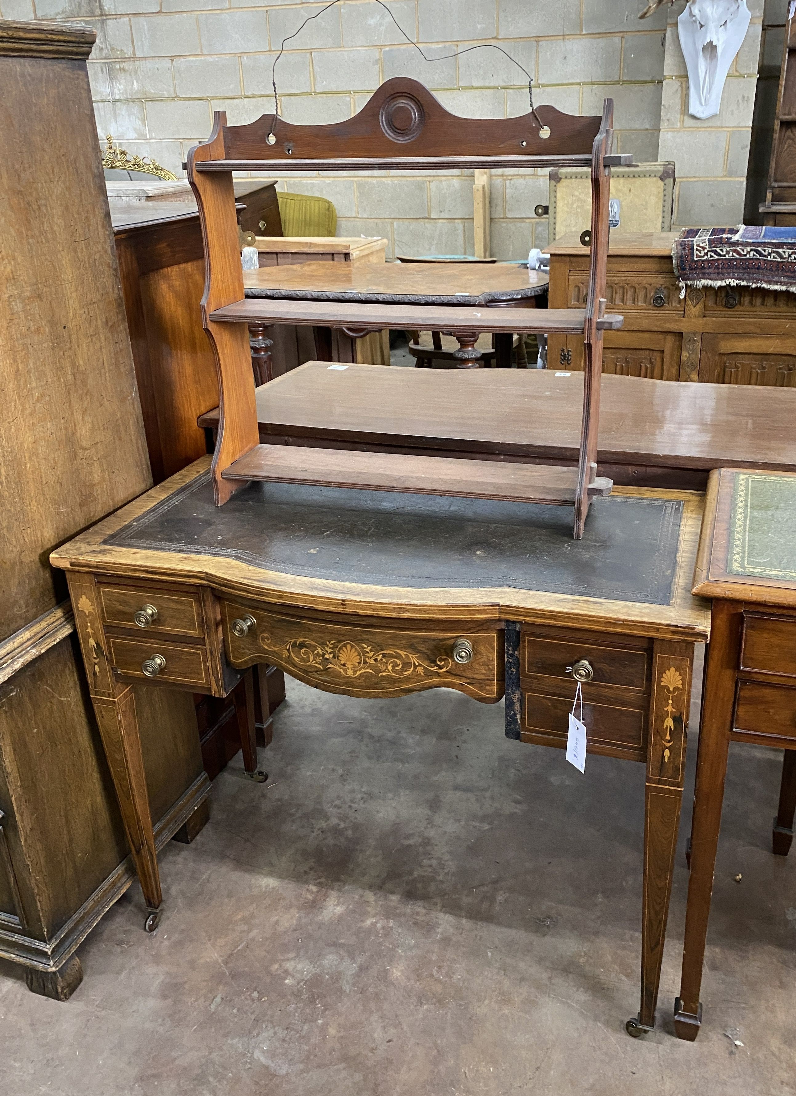 An Edwardian rosewood and marquetry inlaid bow front writing table, width 91cm, depth 49cm, height