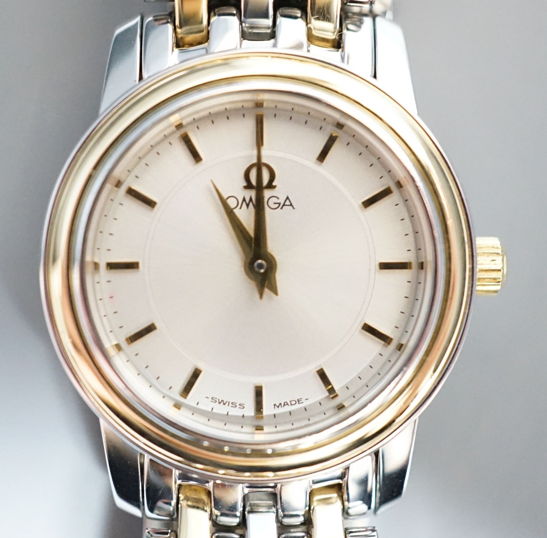 A lady's steel and gold plated Omega quartz wrist watch, on steel and gold plated Omega bracelet,