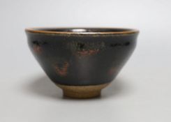 A Chinese black and red pottery bowl - 7.5cm tall