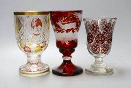 Three Bohemian wheel engraved ruby glass goblets, tallest 16.5cm