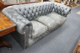 A deep buttoned faded black leather Chesterfield three seater settee, length 210cm, depth 90cm,