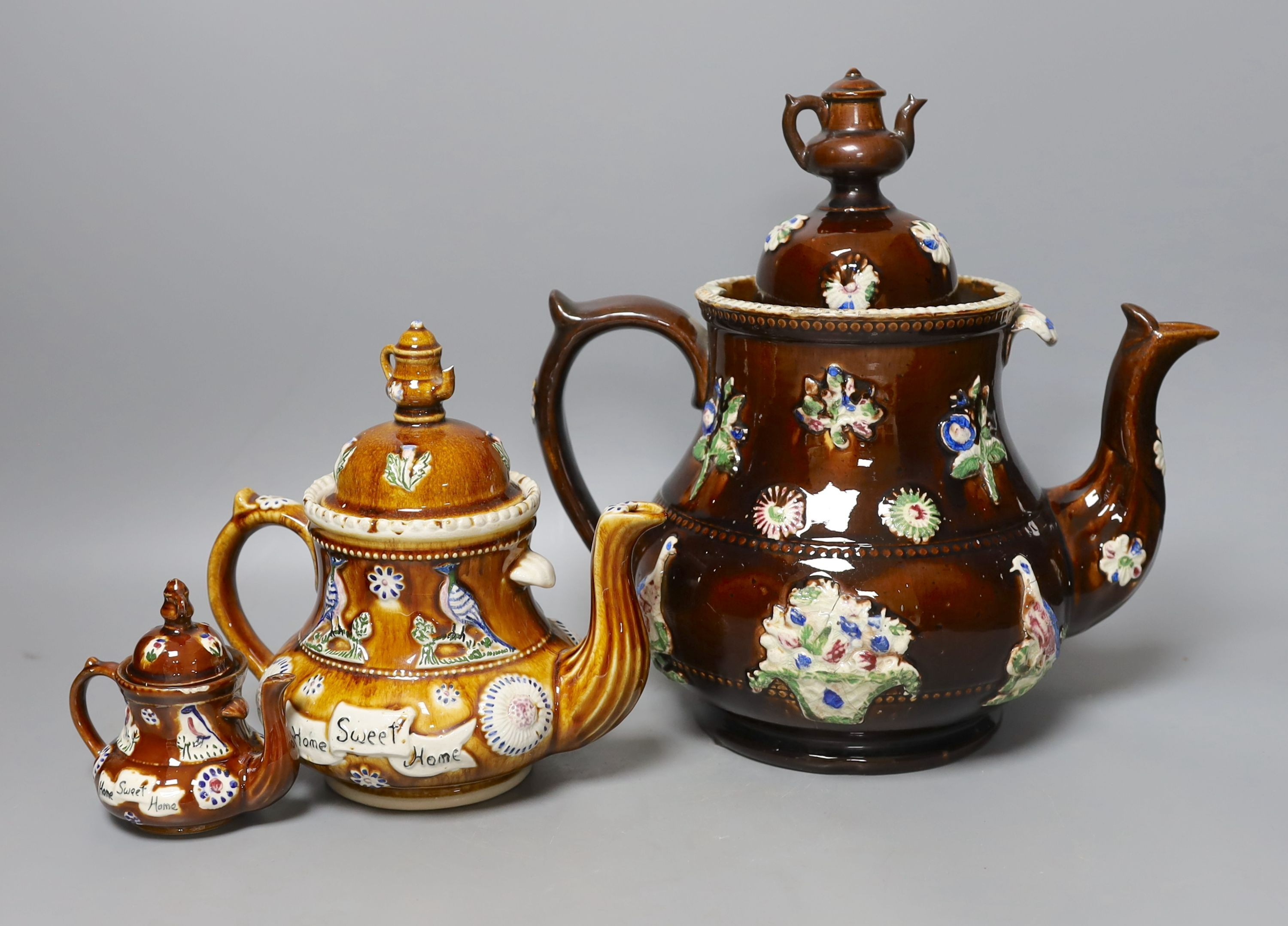 A Measham Bargeware pottery tea pot and cover and two similar reproductions - Image 2 of 2