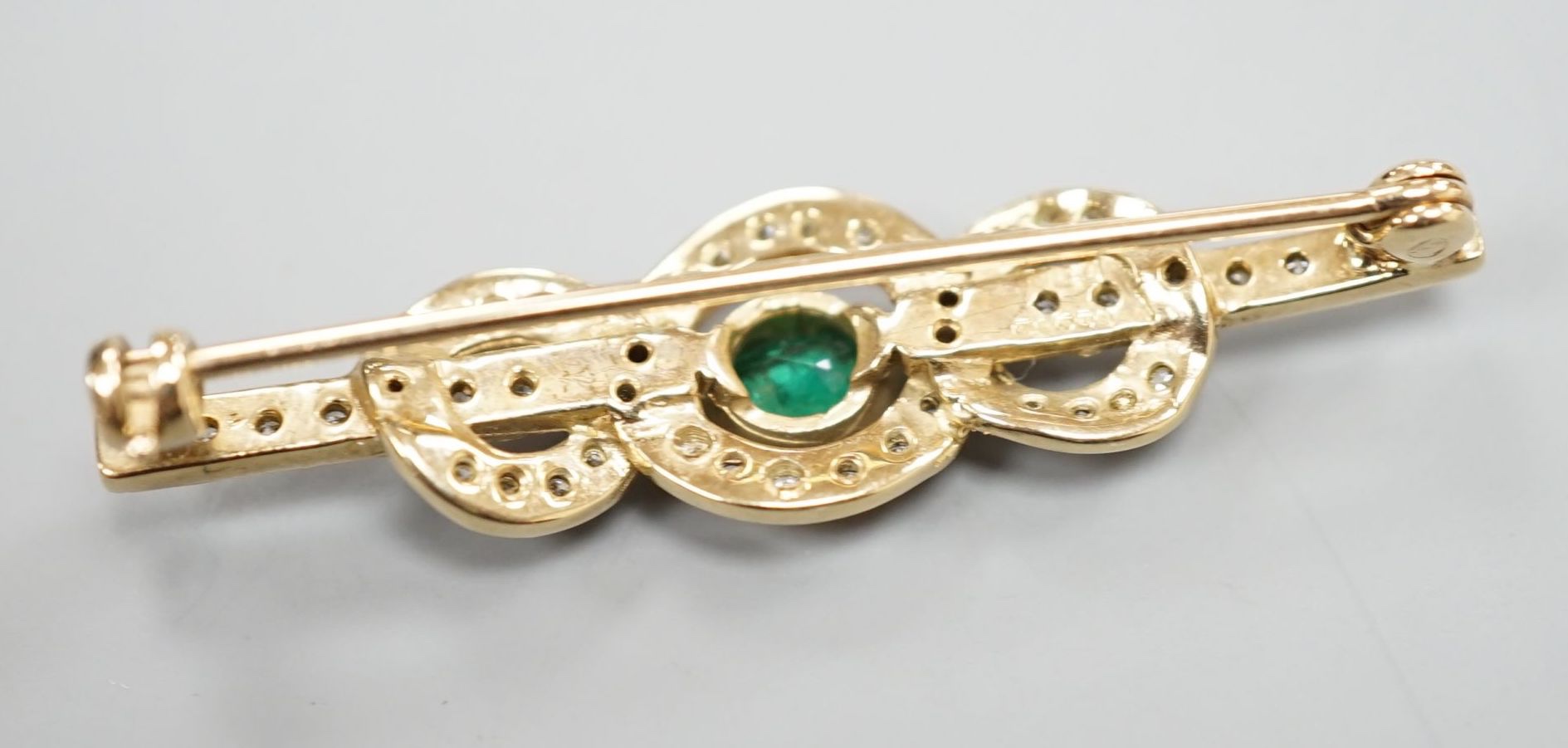 A modern 9ct gold, emerald and diamond cluster set bar brooch, 43mm, gross 3.9 grams. - Image 2 of 2