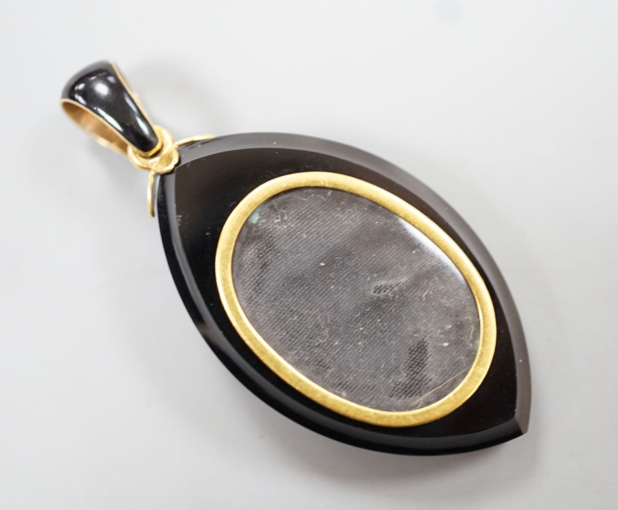 A Victorian yellow metal, black enamel, black onyx and seed pearl set mourning pendant, 57mm. - Image 2 of 2