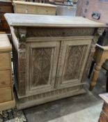 A late 19th century Flemish carved bleached oak two door side cabinet, width 106cm, depth 50cm,