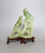 A bowenite jade bird group on wooden base - 23cm tall