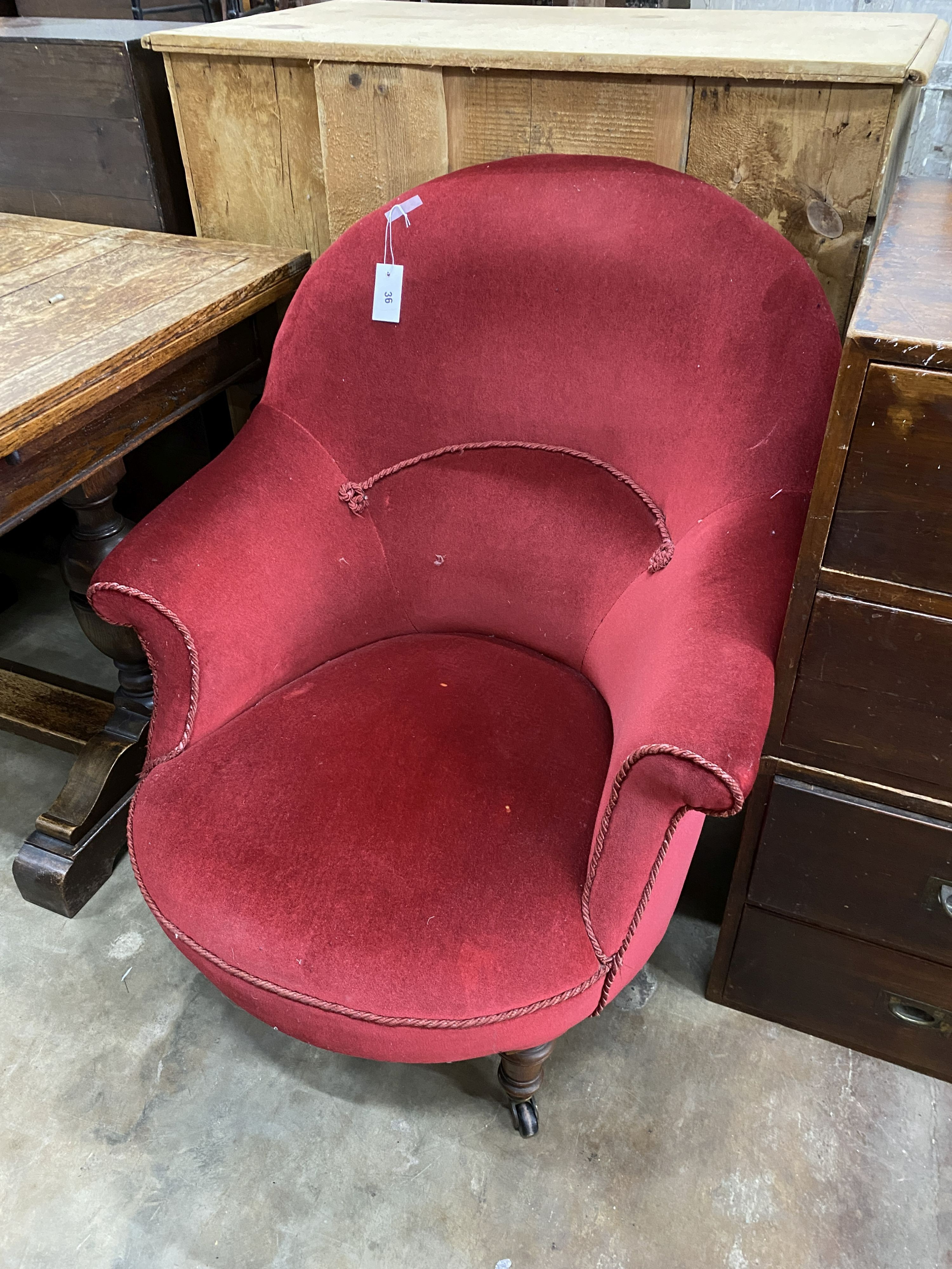 A late Victorian nursing chair upholstered in red dralon, width 78cm, depth 80cm, height 92cm