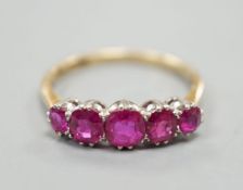 An early 20th century 18ct and plat, graduated five stone ruby set half hoop ring, size Q, gross