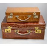 Two early 20th century crocodile hide suitcases,largest 48cms wide x 33 cms deep x 19cms high.