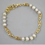 A yellow metal and baroque pearl set fancy link bracelet, 18cm,gross weight 8.1 grams.