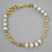 A yellow metal and baroque pearl set fancy link bracelet, 18cm,gross weight 8.1 grams.