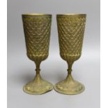 A pair of Middle Eastern repousse gilt metal goblets,22cms high.