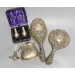 A cased pair of George V silver condiments, an engraved silver purse, silver mounted mirror and