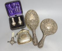 A cased pair of George V silver condiments, an engraved silver purse, silver mounted mirror and