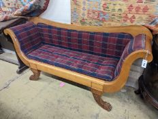 A Biedermier style cherry scroll arm settee with buttoned squab cushion on carved claw feet,