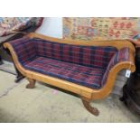 A Biedermier style cherry scroll arm settee with buttoned squab cushion on carved claw feet,