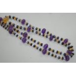 A modern single strand fluted amethyst and facet cut sapphire, citrine and aquamarine bead set