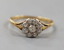 A yellow metal and nine stone diamond set flower head cluster ring, size Q,gross weight 2.4 grams.