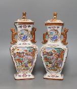 A pair of 18th century Chinese export square form famille rose vases and covers with phoenix handles