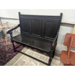 An Arts and Crafts panelled oak settle, length 109cm, depth 42cm, height 107cm