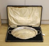 A cased George V silver two handled tea tray, with engraved inscription and crest, Synyer & Beddoes,