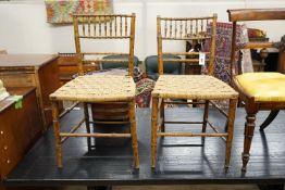 A pair of Regency faux bamboo cane seated chairs