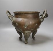 An Oriental two handled elephant footed bronze bowl,24 cms high not including handles.