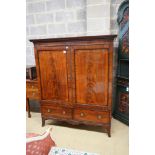 A 19th century mahogany linen press of small proportions, with panelled flamed mahogany doors