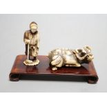Two Japanese stag antler carvings - a Tomotada style ox netsuke, 7cm long, and a lady, 6.5cm