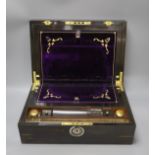 A 19th century coromandel wood writing slope with mother-of-pearl cartouche and original purple