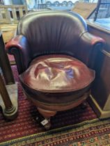 An early 20th century oak and burgundy leather tub framed swivel desk chair, width 70cm, depth 60cm,