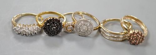 Four assorted modern 9ct gold and white or coloured diamond cluster set dress rings and two